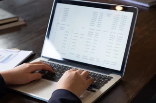 A business owner reviewing key analytics numbers on a laptop