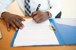 A business owner signing a contract that includes a copyright a